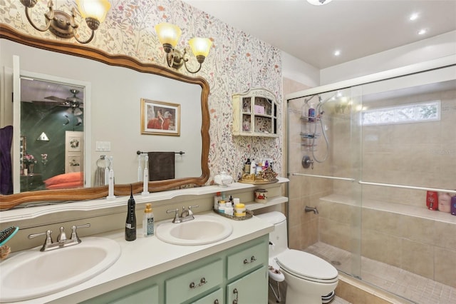 bathroom with wallpapered walls, a stall shower, double vanity, toilet, and a ceiling fan