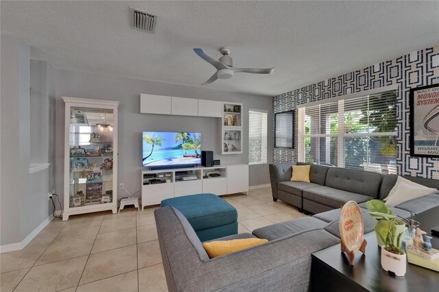 5914 Goldenbark Pl, Lithia, FL 33547 - living area with a textured ceiling, light tile patterned flooring, ceiling fan, and baseboards