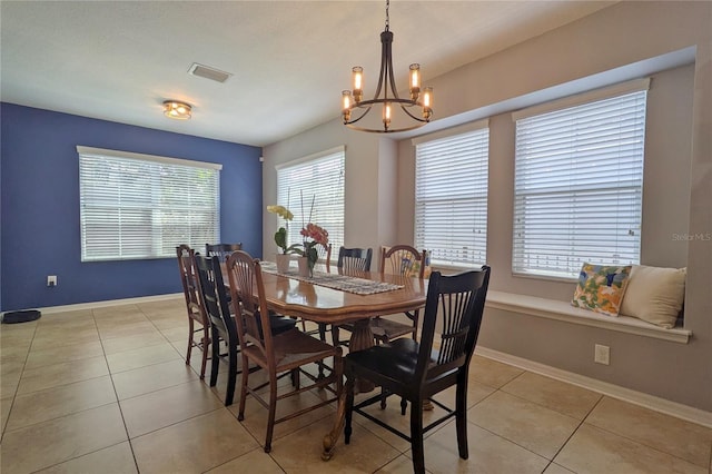 5914 Goldenbark Pl, Lithia, FL 33547 - dining room featuring a chandelier, light tile patterned flooring, and baseboards