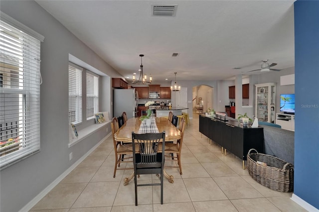 5914 Goldenbark Pl, Lithia, FL 33547 - dining space featuring a chandelier, ceiling fan, light tile patterned flooring, and baseboards