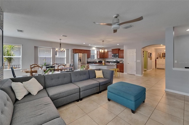 5914 Goldenbark Pl, Lithia, FL 33547 - living room featuring a chandelier, a ceiling fan, arched walkways, light tile patterned floors, and recessed lighting