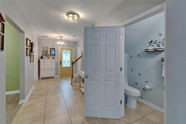 5914 Goldenbark Pl, Lithia, FL 33547 - bathroom featuring a chandelier, vanity, tile patterned floors, toilet, and a textured ceiling