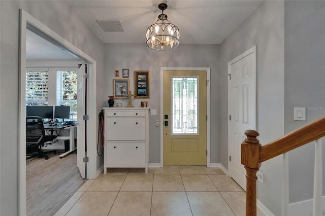 5914 Goldenbark Pl, Lithia, FL 33547 - entryway with a chandelier, baseboards, and light tile patterned floors