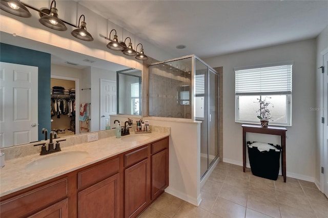 5914 Goldenbark Pl, Lithia, FL 33547 - bathroom with a shower stall, tile patterned floors, double vanity, and a spacious closet