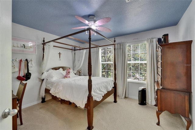 5914 Goldenbark Pl, Lithia, FL 33547 - carpeted bedroom featuring baseboards, a textured ceiling, and a ceiling fan