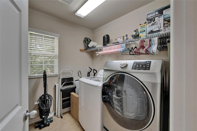 5914 Goldenbark Pl, Lithia, FL 33547 - laundry room with washer and clothes dryer and light tile patterned floors
