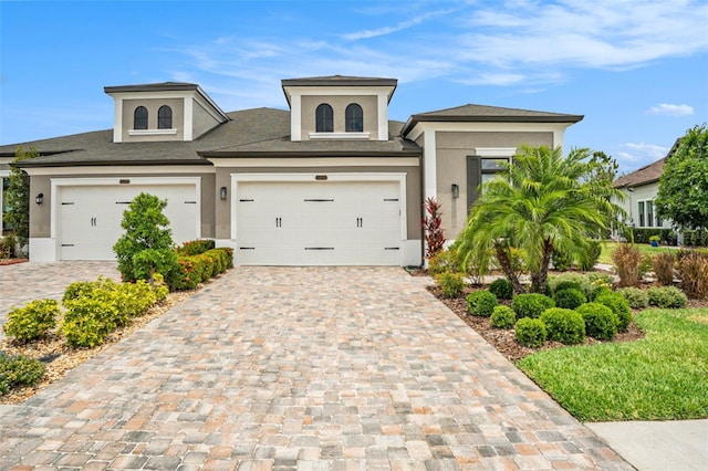 4329 Barletta Ct, Wesley Chapel, FL 33543 - view of front of home featuring stucco siding, decorative driveway, and a shingled roof