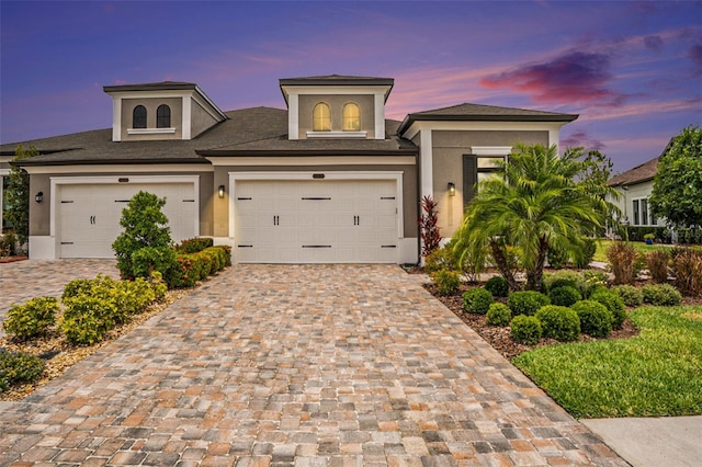 4329 Barletta Ct, Wesley Chapel, FL 33543 - view of front facade with stucco siding, decorative driveway, and roof with shingles