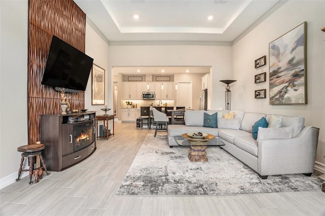 4329 Barletta Ct, Wesley Chapel, FL 33543 - living room with a tray ceiling, recessed lighting, and baseboards
