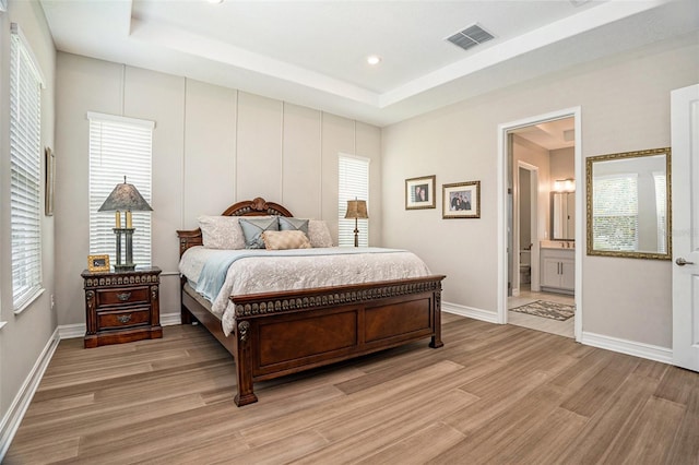 4329 Barletta Ct, Wesley Chapel, FL 33543 - bedroom with light wood finished floors, a raised ceiling, multiple windows, and recessed lighting