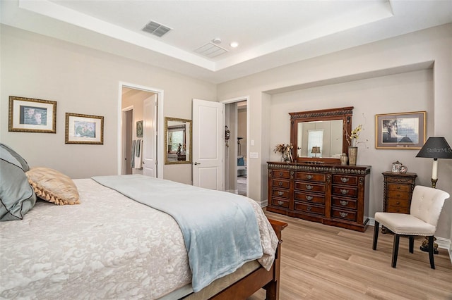 4329 Barletta Ct, Wesley Chapel, FL 33543 - bedroom featuring a tray ceiling, light wood-style floors, recessed lighting, and baseboards