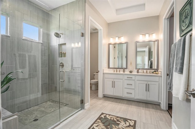 4329 Barletta Ct, Wesley Chapel, FL 33543 - bathroom with toilet, double vanity, a shower stall, and baseboards