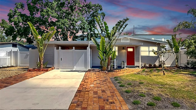 4735 W Oklahoma Ave, Tampa, FL 33616 - mid-century inspired home featuring driveway, fence, and a carport