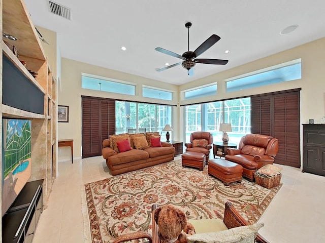 16343 Burniston Dr, Tampa, FL 33647 - living room with a ceiling fan, light tile patterned floors, recessed lighting, and a towering ceiling
