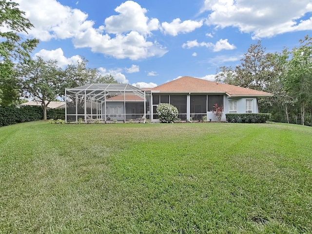 16343 Burniston Dr, Tampa, FL 33647 - rear view of property featuring a yard and a tile roof