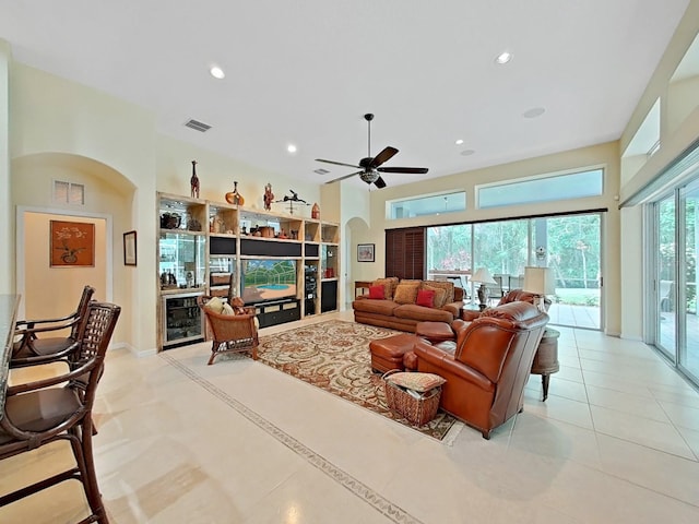 16343 Burniston Dr, Tampa, FL 33647 - living area featuring arched walkways, ceiling fan, recessed lighting, light tile patterned floors, and a high ceiling