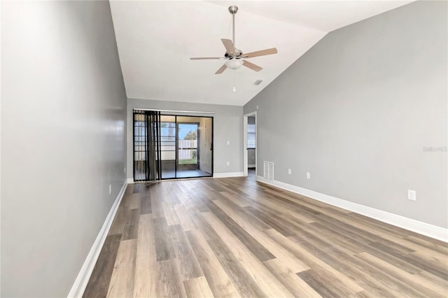 unfurnished room with ceiling fan, wood finished floors, baseboards, and high vaulted ceiling