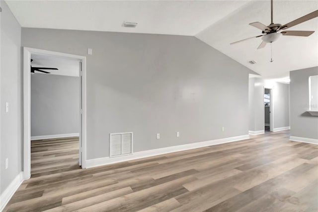 unfurnished living room featuring ceiling fan, lofted ceiling, wood finished floors, and baseboards
