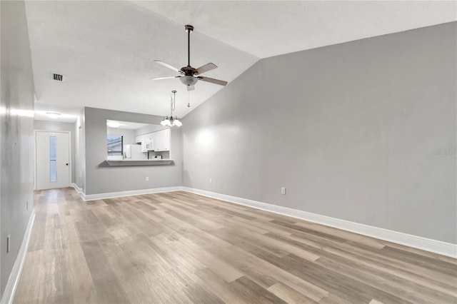 unfurnished living room featuring lofted ceiling, ceiling fan, baseboards, and light wood-style floors