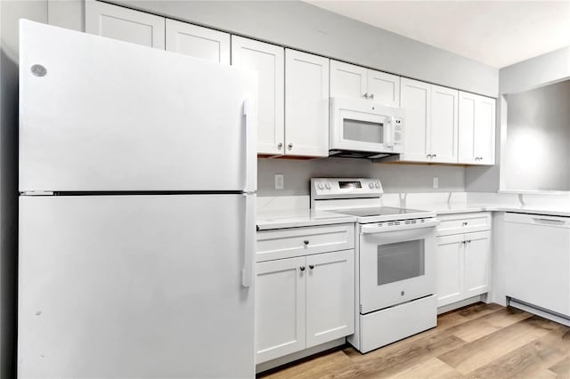 kitchen featuring white appliances, light wood-style floors, white cabinets, and light countertops