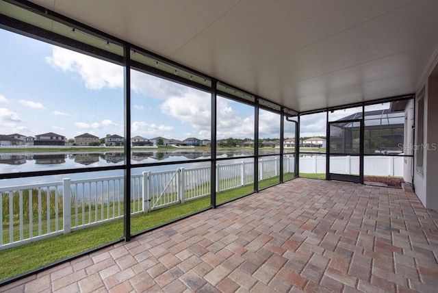 12352 Crestridge Loop, New Port Richey, FL 34655 - unfurnished sunroom featuring a water view and a residential view
