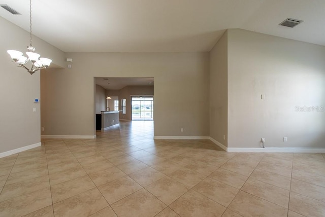 12352 Crestridge Loop, New Port Richey, FL 34655 - empty room with light tile patterned floors, a chandelier, and baseboards