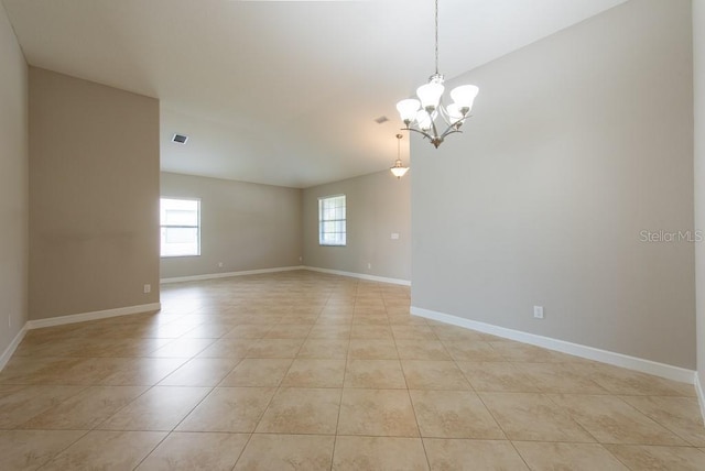 12352 Crestridge Loop, New Port Richey, FL 34655 - empty room featuring light tile patterned flooring, a chandelier, and baseboards