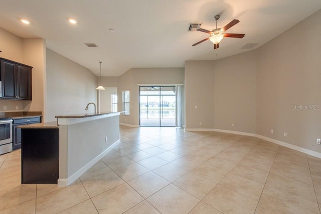 12352 Crestridge Loop, New Port Richey, FL 34655 - kitchen featuring light tile patterned floors, a ceiling fan, vaulted ceiling, baseboards, and stainless steel appliances