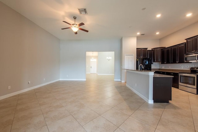 12352 Crestridge Loop, New Port Richey, FL 34655 - kitchen featuring appliances with stainless steel finishes, a ceiling fan, a kitchen island with sink, light tile patterned floors, and open floor plan