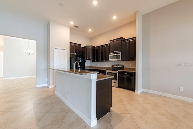 12352 Crestridge Loop, New Port Richey, FL 34655 - kitchen featuring stainless steel appliances, light tile patterned floors, a chandelier, a center island with sink, and recessed lighting