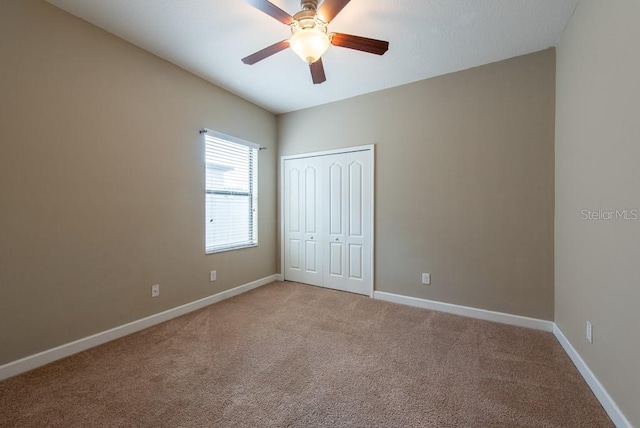 12352 Crestridge Loop, New Port Richey, FL 34655 - unfurnished bedroom featuring light carpet, a closet, baseboards, and ceiling fan