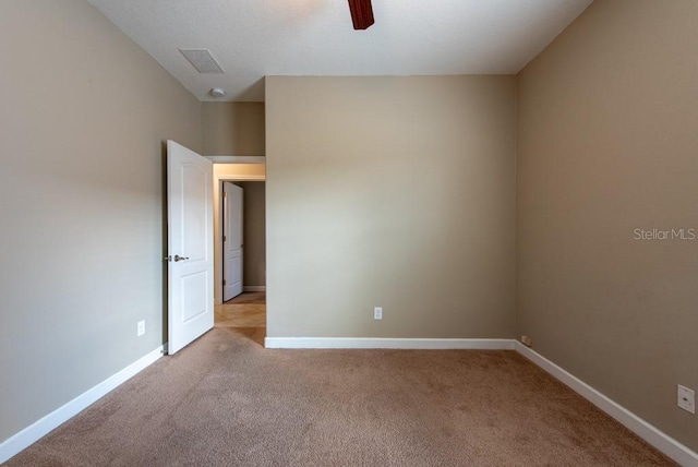 12352 Crestridge Loop, New Port Richey, FL 34655 - spare room featuring light colored carpet, baseboards, and a ceiling fan