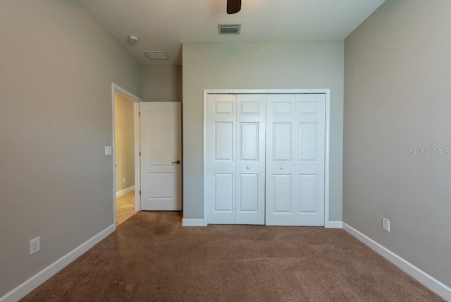 12352 Crestridge Loop, New Port Richey, FL 34655 - unfurnished bedroom featuring carpet floors, a closet, baseboards, and ceiling fan