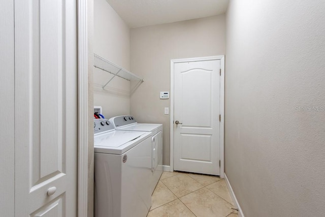 12352 Crestridge Loop, New Port Richey, FL 34655 - laundry area with washer and dryer, light tile patterned flooring, and baseboards