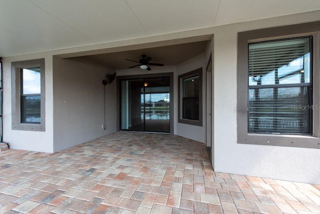 12352 Crestridge Loop, New Port Richey, FL 34655 - property entrance with ceiling fan and stucco siding