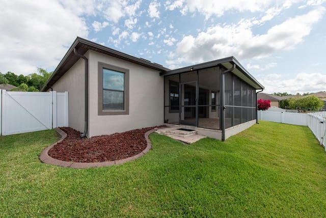 12352 Crestridge Loop, New Port Richey, FL 34655 - rear view of house with a gate, a sunroom, and stucco siding