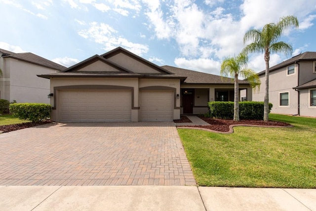 12352 Crestridge Loop, New Port Richey, FL 34655 - single story home with decorative driveway, stucco siding, an attached garage, and a front yard
