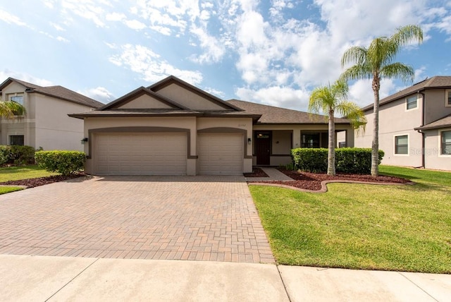12352 Crestridge Loop, New Port Richey, FL 34655 - ranch-style house featuring decorative driveway, a garage, a front yard, and stucco siding
