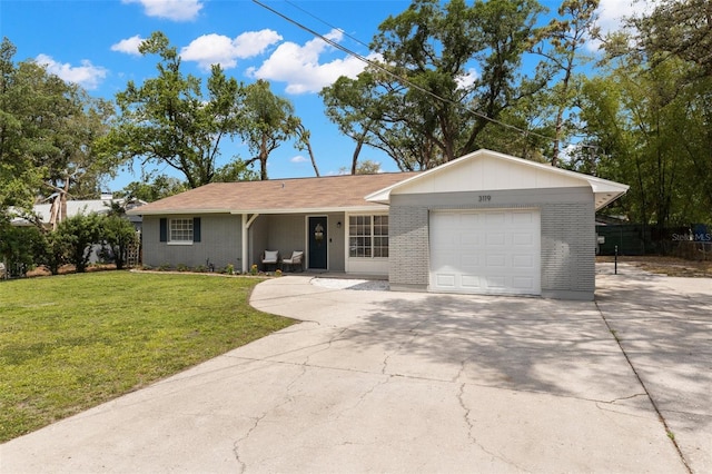 3119 W N St, Tampa, FL 33614 - single story home with a garage, brick siding, driveway, and a front yard