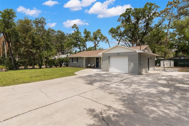 3119 W N St, Tampa, FL 33614 - ranch-style house with a garage, a storage shed, driveway, brick siding, and a front yard