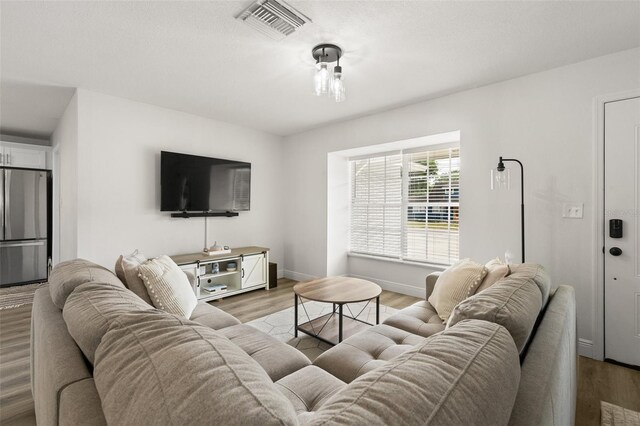 3119 W N St, Tampa, FL 33614 - living room with light wood-style floors and baseboards