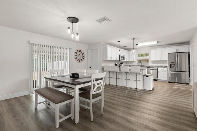 3119 W N St, Tampa, FL 33614 - dining room featuring wood finished floors and baseboards