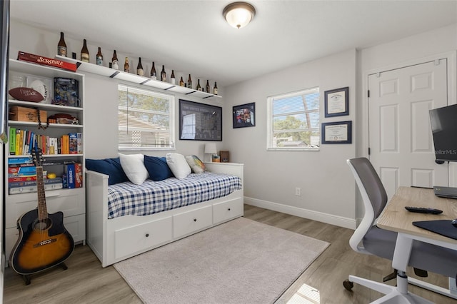 3119 W N St, Tampa, FL 33614 - bedroom featuring wood finished floors, an office area, and baseboards