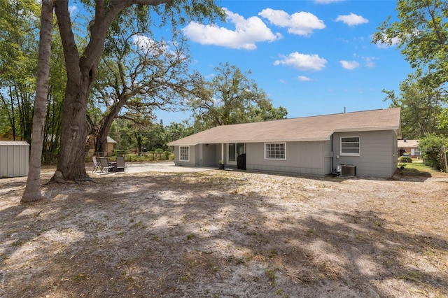 3119 W N St, Tampa, FL 33614 - rear view of house featuring central AC, a patio, and an outdoor structure