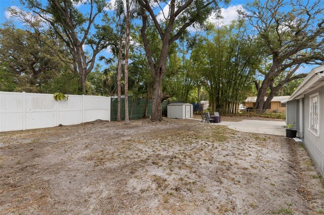 3119 W N St, Tampa, FL 33614 - view of yard with a storage unit, fence, an outdoor structure, and a patio