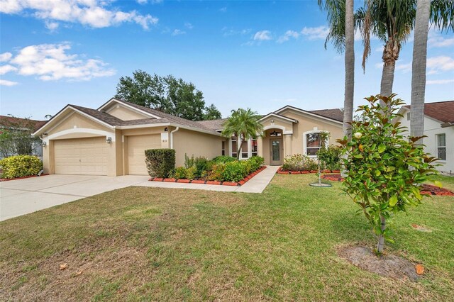 815 Sandy Trail Pl, Brandon, FL 33511 - ranch-style home featuring stucco siding, an attached garage, concrete driveway, and a front yard