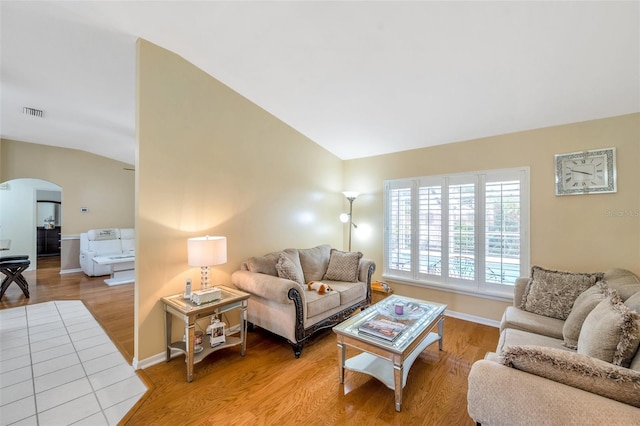 815 Sandy Trail Pl, Brandon, FL 33511 - living area featuring arched walkways, vaulted ceiling, light wood-style flooring, and baseboards