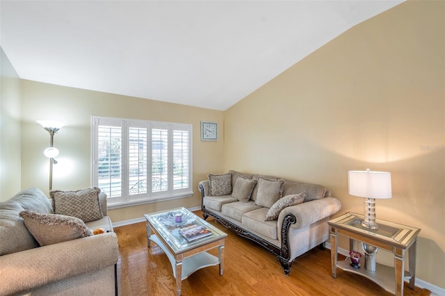 815 Sandy Trail Pl, Brandon, FL 33511 - living area featuring vaulted ceiling, light wood-style floors, and baseboards