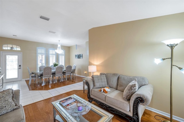 815 Sandy Trail Pl, Brandon, FL 33511 - living room featuring a chandelier, wood finished floors, and baseboards