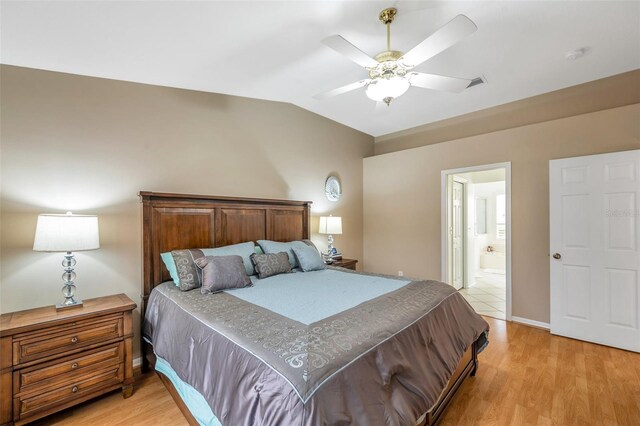 815 Sandy Trail Pl, Brandon, FL 33511 - bedroom with light wood-style flooring, lofted ceiling, ensuite bathroom, ceiling fan, and baseboards